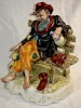 Capodimonte ceramic figurine man on bench with wine bottle Italy